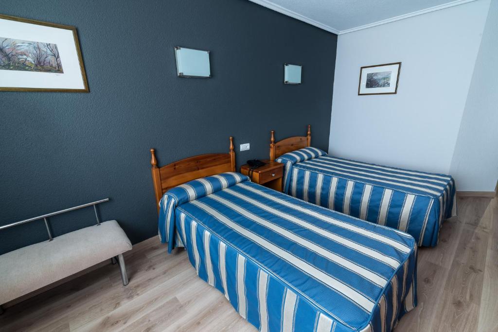 桑坦德圣格洛里奥酒店的酒店客房,设有两张床和一张沙发