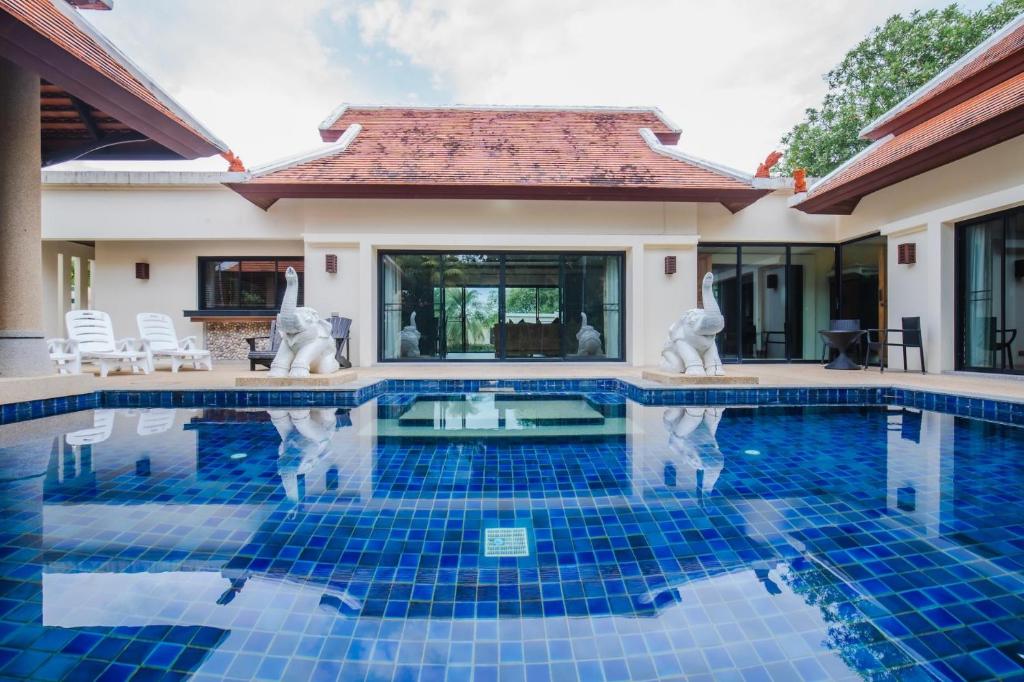 拉威海滩Lotus Pool Villa的一座带游泳池和房子的别墅