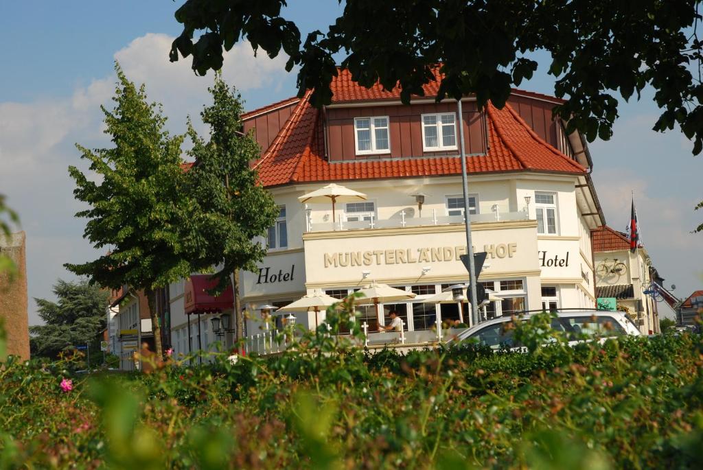 克洛彭堡姆斯特兰登酒店的一座白色的大建筑,有红色的屋顶