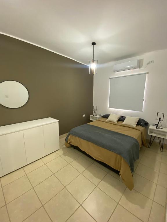 奇莱西托Departamento Cristo del Portezuelo I的一间卧室设有一张大床和白色的墙壁