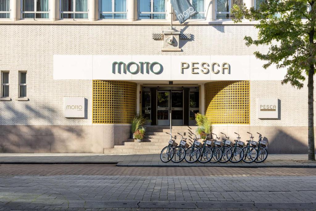 鹿特丹Motto By Hilton Rotterdam Blaak的停在商店前的一群自行车