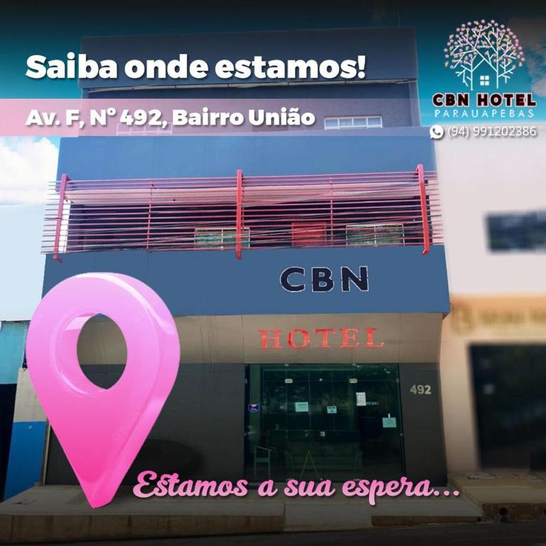 帕劳阿佩巴斯CBN HOTEL的酒店前面有一个粉红色的标志