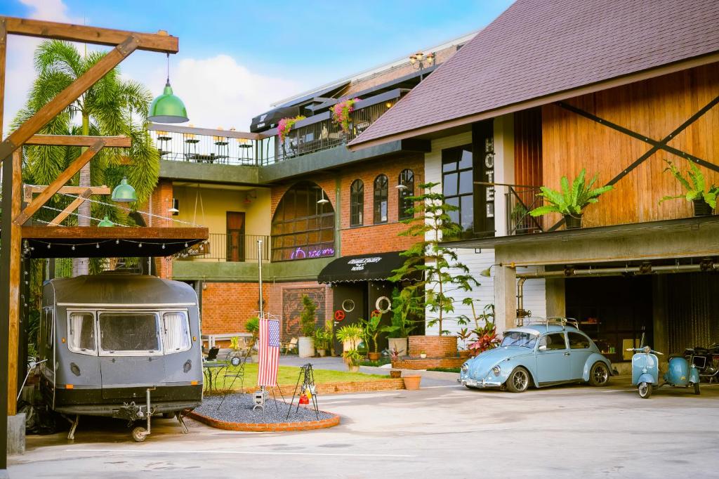 乌隆他尼Dream Factory Hotel的旧车停在大楼前