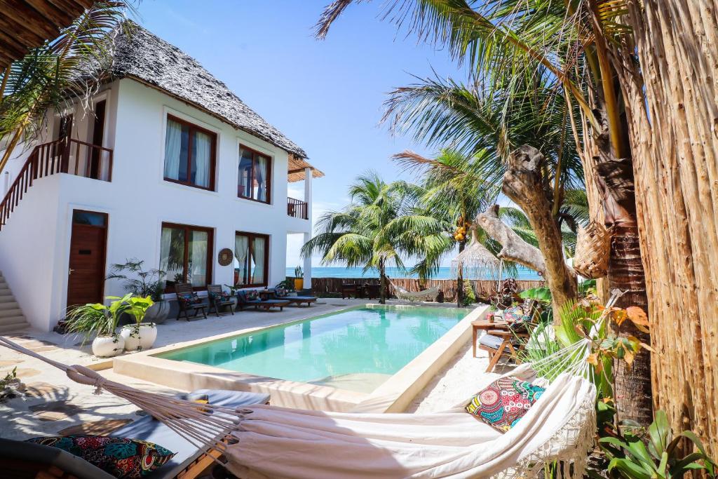 江比阿Babu Villas的一座别墅,设有游泳池和棕榈树