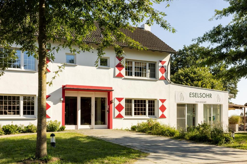 韦策Schloss Hertefeld & Hertefeldhof的享有白色建筑的外部景色,拥有红色点缀