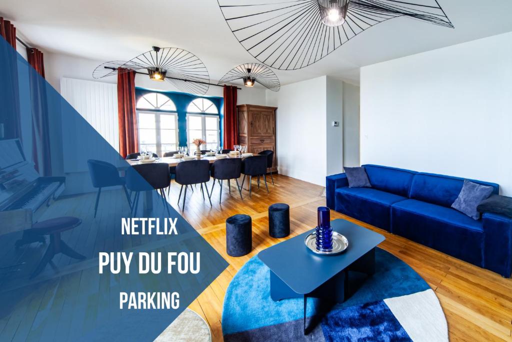 MauléonJolie m'Home*Le Puy du Fou的客厅配有蓝色的沙发和桌子
