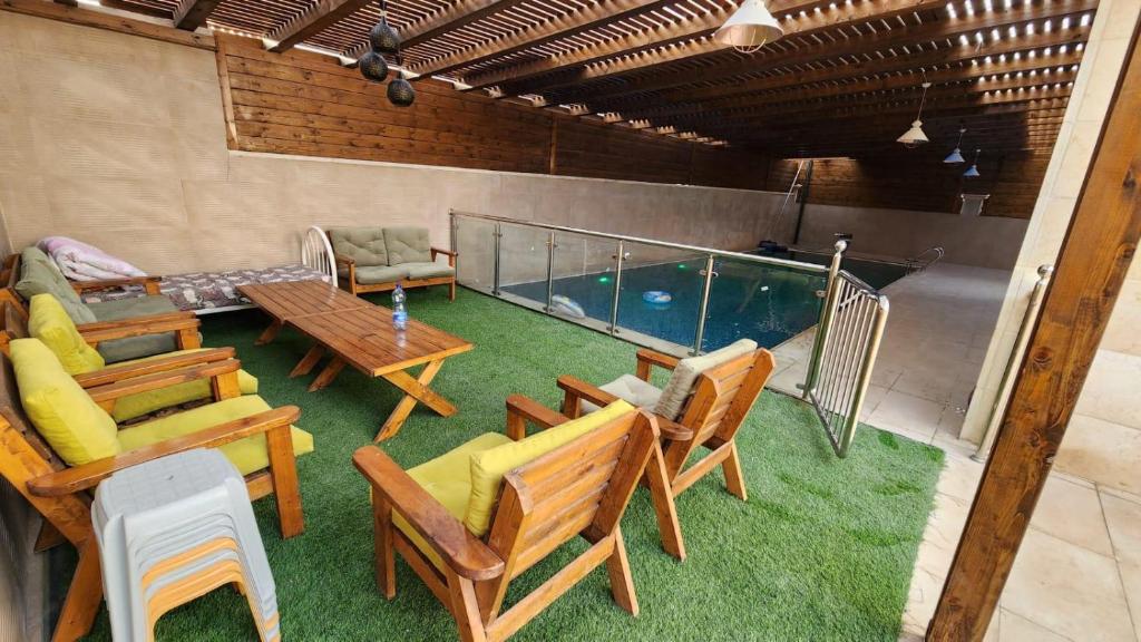 杰里科alzain villas - فلل الزين اريحا的一个带桌椅的庭院和一个游泳池