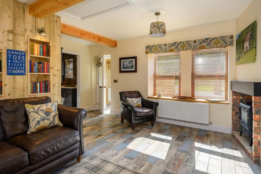 圣安德鲁斯Country Cottage by St. Andrews的带沙发和壁炉的客厅