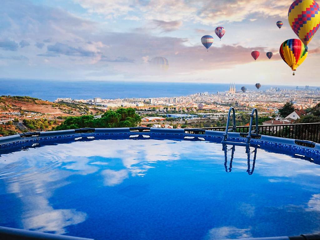 巴达洛纳A+View Private Terrace Private Pool Family Fun的一座大型游泳池,在天空中设有热气球