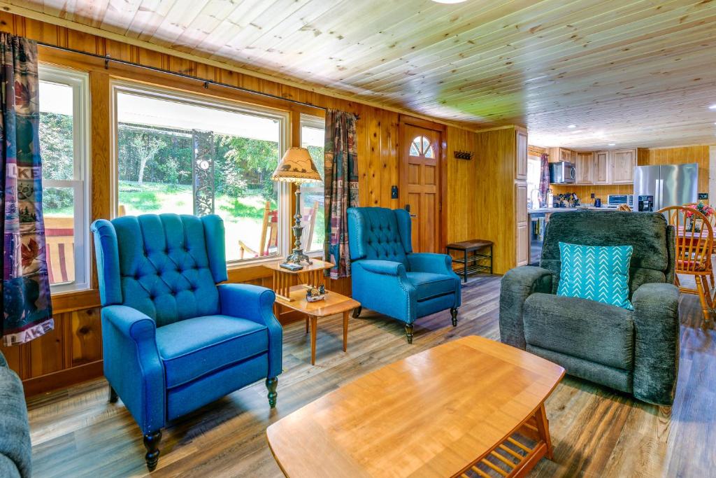 科斯比Rustic Cosby Cabin with Furnished Deck and Yard!的客厅配有蓝色的椅子和桌子