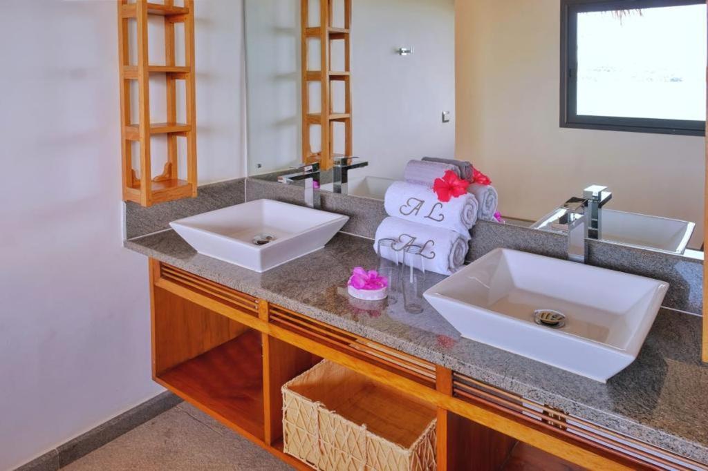 贝岛ANJARA LODGE Villa de 3 chambres的浴室柜台设有两个盥洗盆和镜子