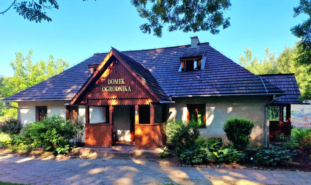 普热沃斯克Hostel Domek Ogrodnika przy Muzeum w Przeworsku Zespole Pałacowo - Parkowym的带有读鸭餐厅标志的房子