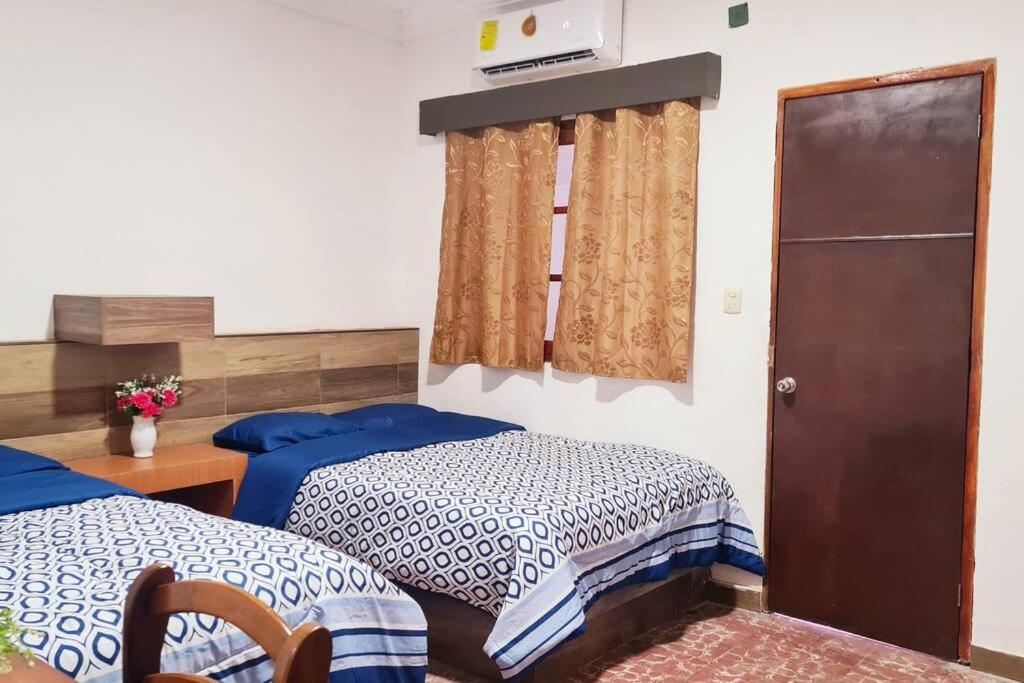 韦拉克鲁斯Alojamiento completo en el centro的一间卧室配有两张带蓝白色床单的床