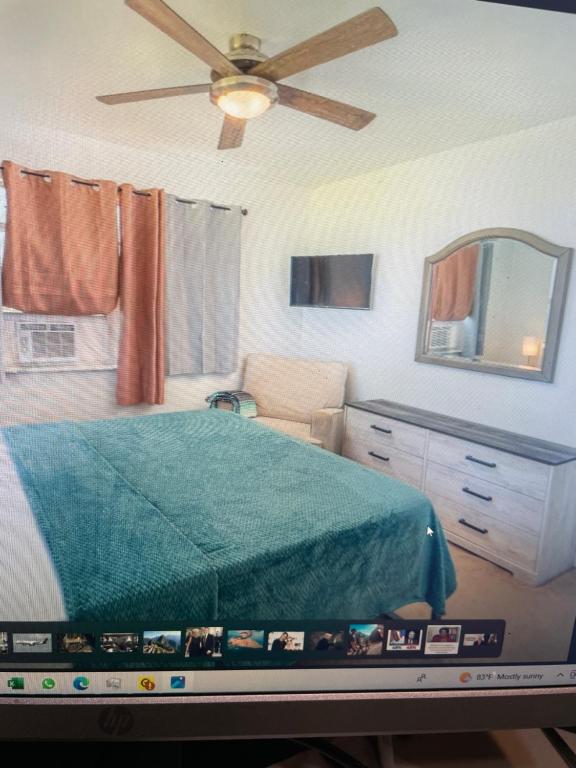 大特克岛John’s Place的一间卧室配有一张床和吊扇