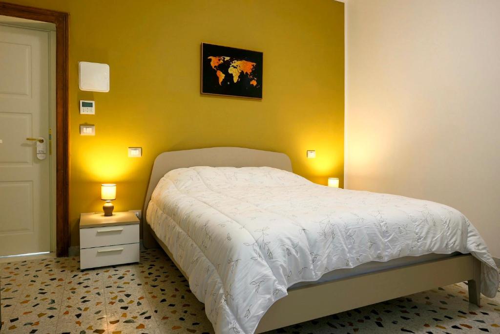 阿韦扎诺Al Castello Avezzano的卧室配有白色的床和黄色的墙壁