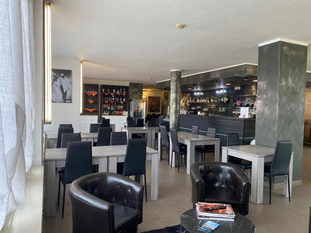 沃尔皮亚诺维迪娜酒店的一间带桌椅的餐厅和一间酒吧