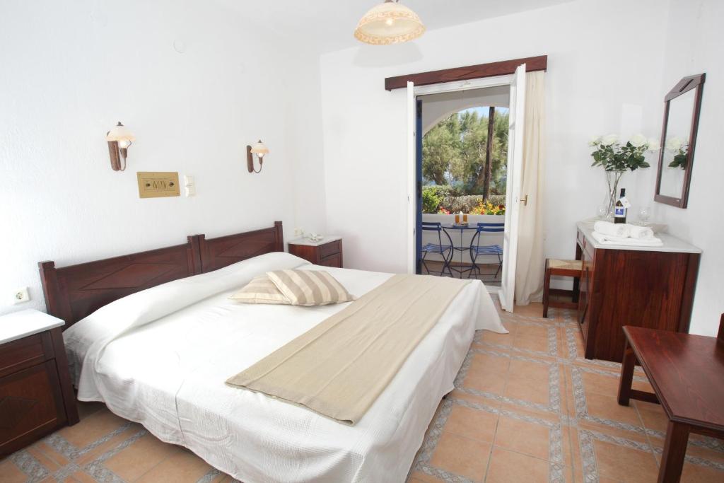 洛加拉斯帕罗酒店的一间卧室配有一张床、一张桌子和一个窗户。