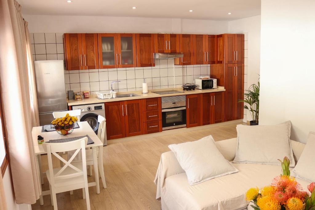 下布雷尼亚Mary (A): Confort y playa.的厨房以及带沙发和桌子的客厅。