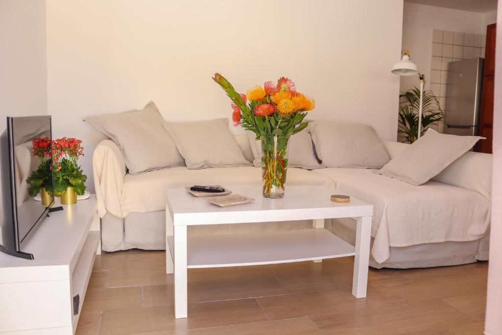 下布雷尼亚Beatriz (C): Tranquilidad y playa.的客厅配有沙发和花瓶(桌子上)