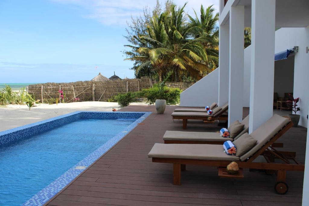帕杰Kivuli Beach Resort Paje的毗邻度假酒店的带躺椅的游泳池