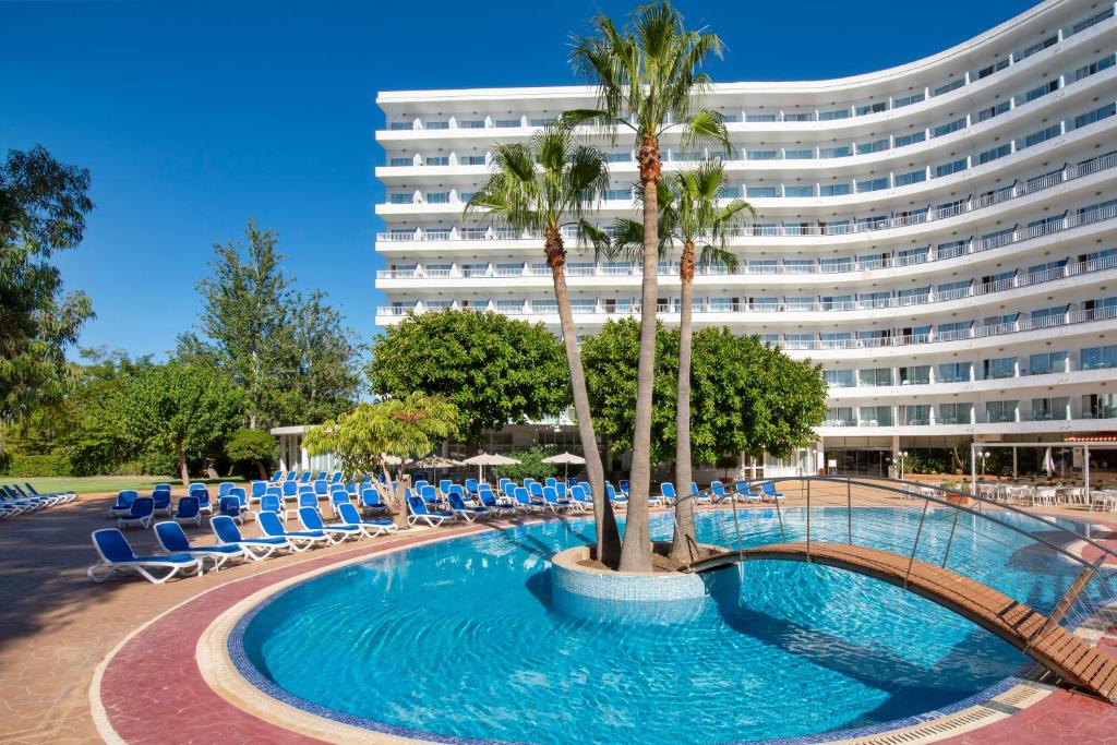 马盖鲁夫圣米歇尔大西洋公园酒店的一座带游泳池和椅子的酒店和一座建筑