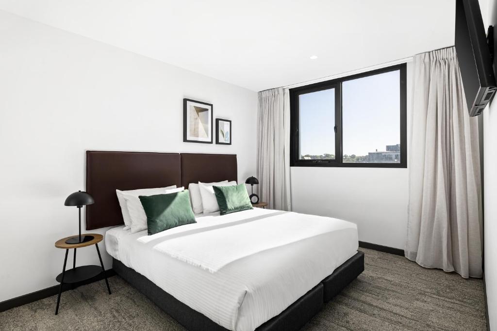吉朗Quest Geelong Central的一间卧室设有一张大床和一个大窗户