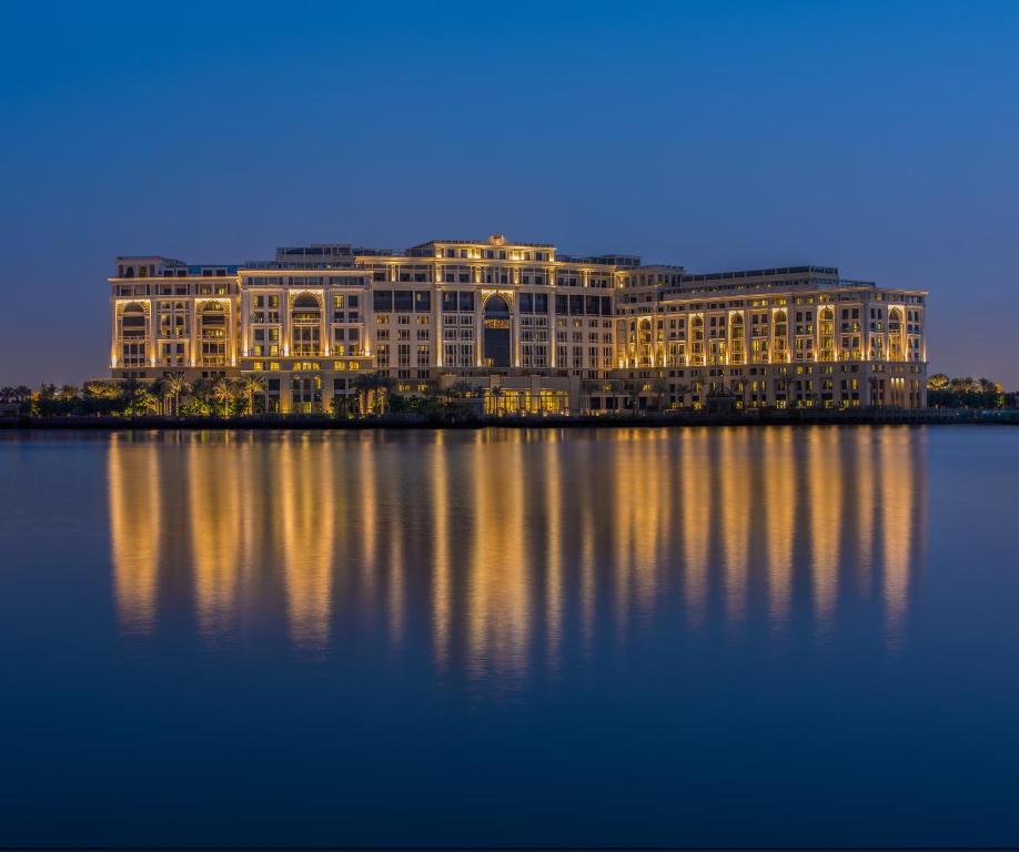迪拜迪拜范思哲酒店的一座大建筑,晚上坐在水面上