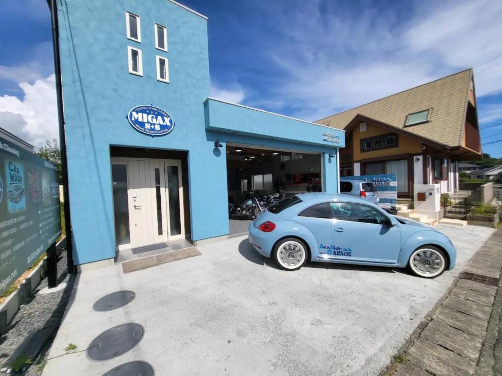 志摩市Seaside Garage Shima - Vacation STAY 77073v的停在大楼前的蓝色汽车