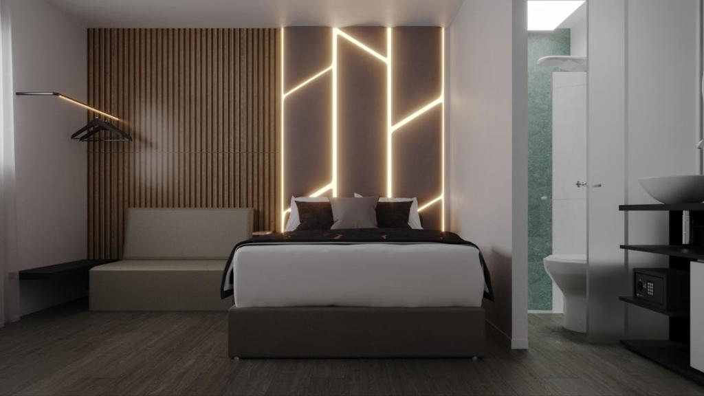 圣保罗International Stay - Suites/Apês Novíssimo, Moderno, Aconchegante, Bem Localizado e Econômico!的卧室配有一张挂在墙上的灯光床。