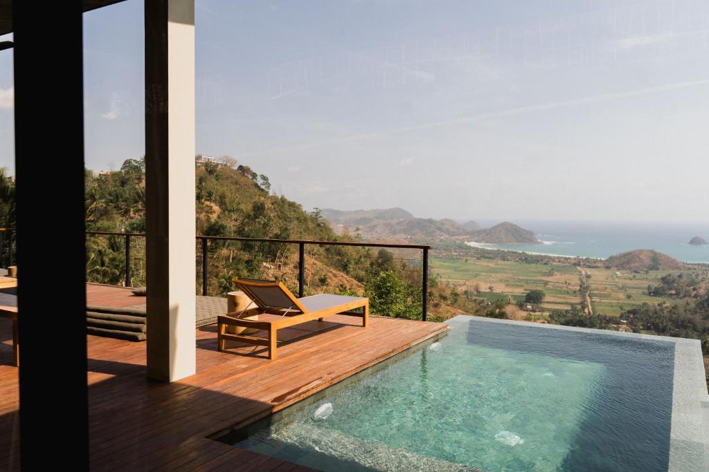 塞隆贝拉纳克DUNIA LOMBOK - Villas with Ocean View的一个带游泳池和甲板椅的别墅