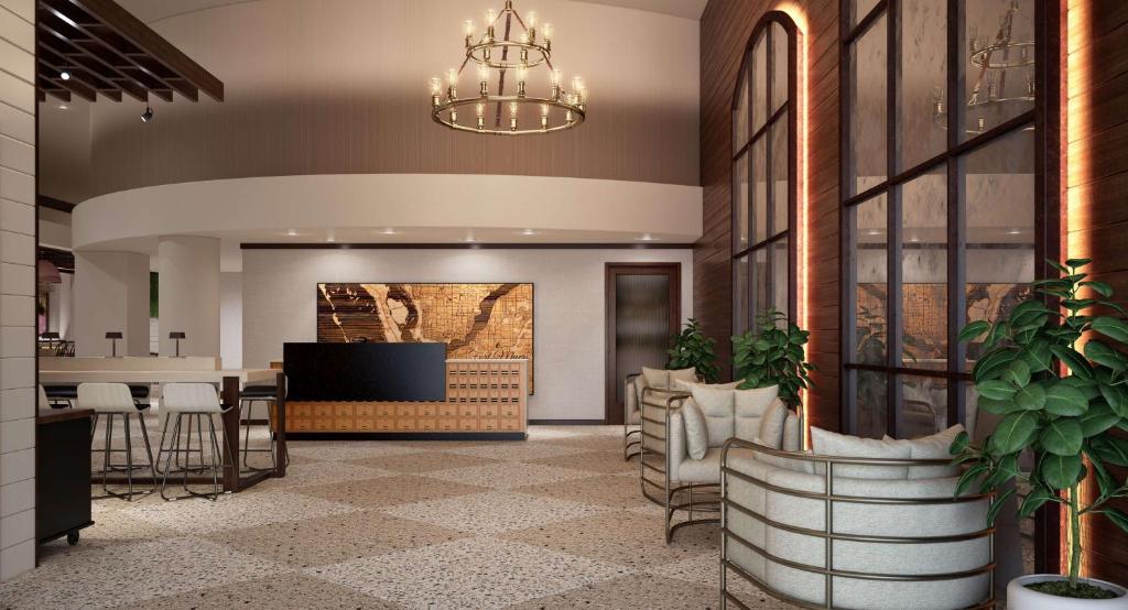 迈尔斯堡The Banyan Hotel Fort Myers, Tapestry Collection by Hilton的大堂设有酒吧和用餐区