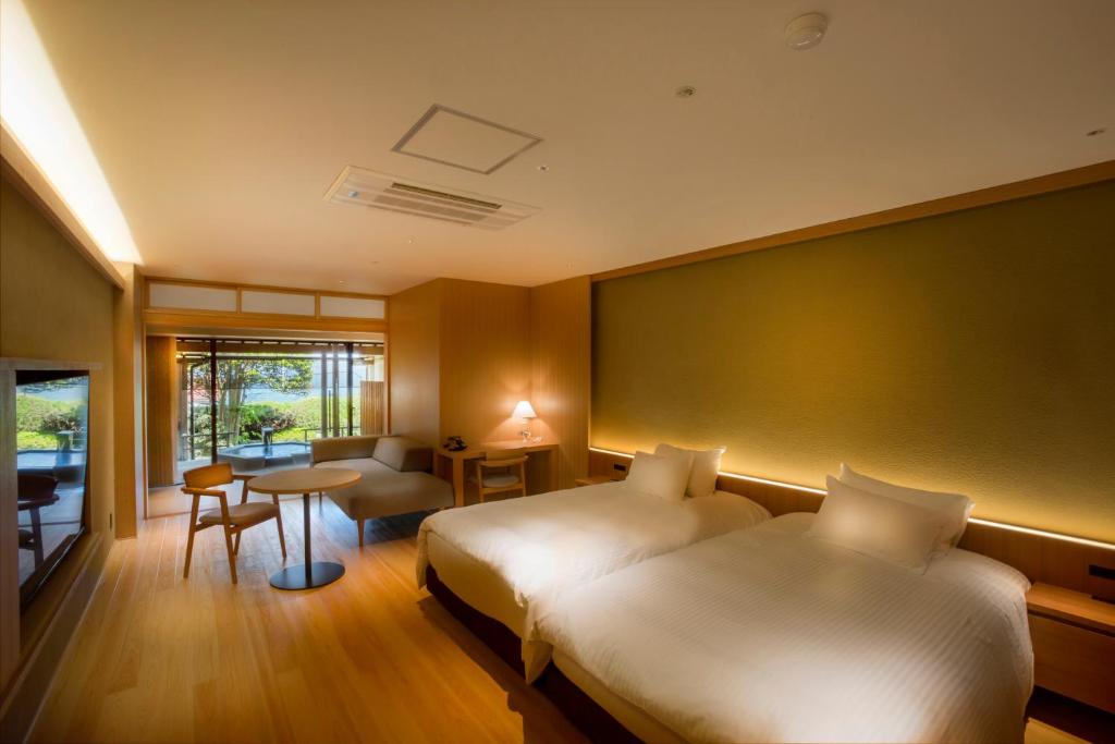 宫津市奇塔诺亚酒店的酒店客房设有两张床和一张桌子。
