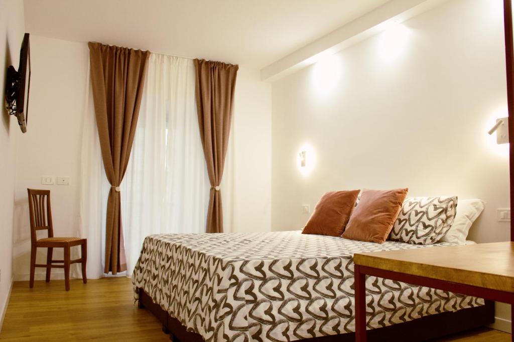 罗马乔欧酒店的卧室配有床、椅子和窗户。