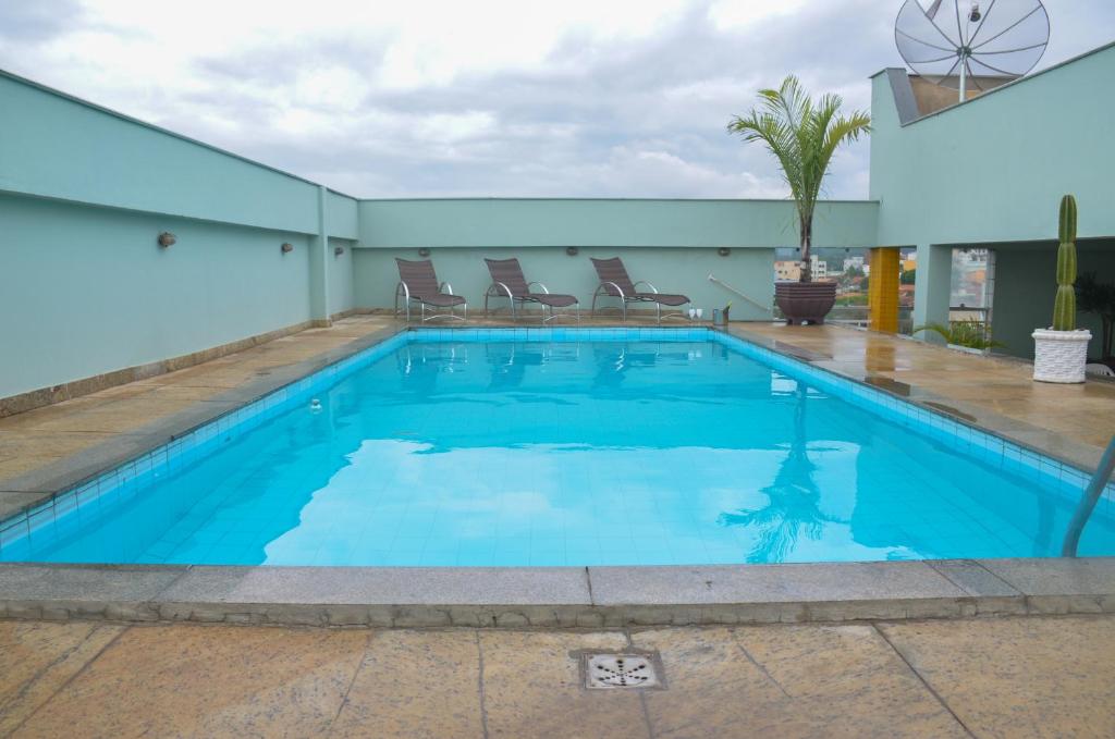 塞蒂拉瓜斯Riviera Palace Hotel的大楼内的一个蓝色海水游泳池