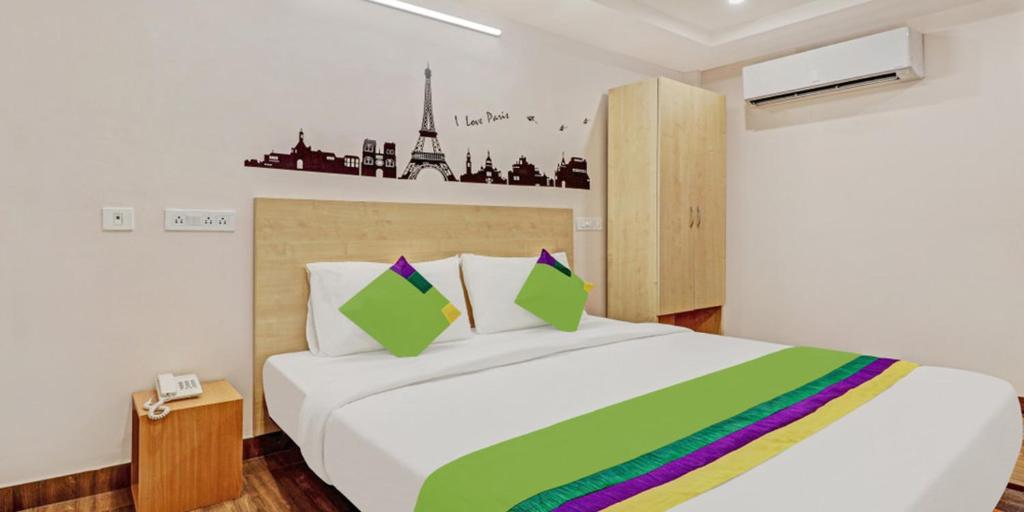 卡基纳达De Crown Luxury Hotel的一间卧室配有一张大白色的床和色彩缤纷的毯子