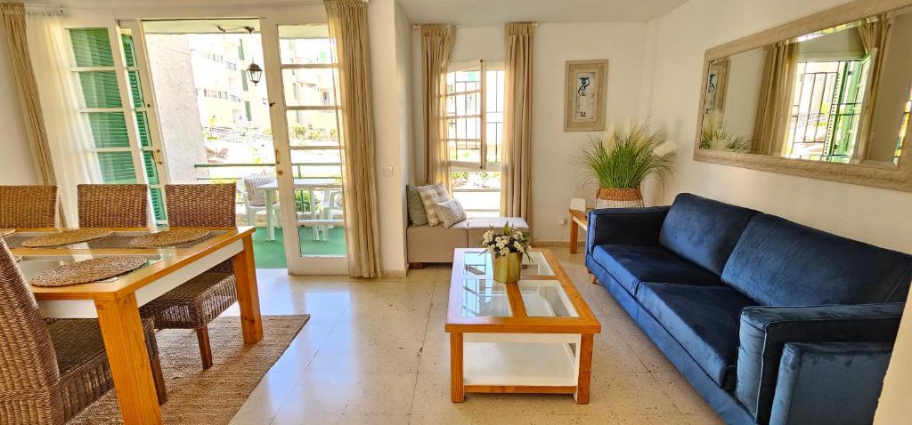 美洲海滩Viñas by Villas Rinamar的客厅配有蓝色的沙发和桌子