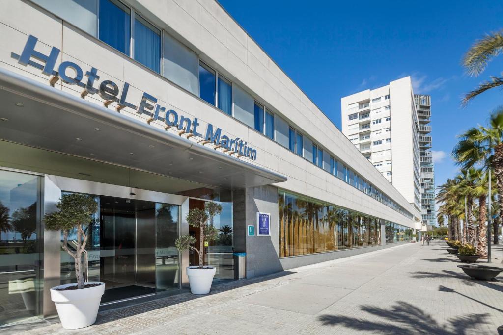 巴塞罗那福让特玛丽提姆最佳酒店的一座医院大楼前面有棕榈树