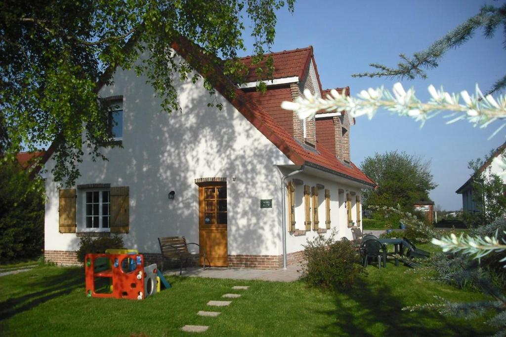 Saint-Pol-sur-TernoiseGîte 2 pers的白色的房子,有红色的屋顶和院子