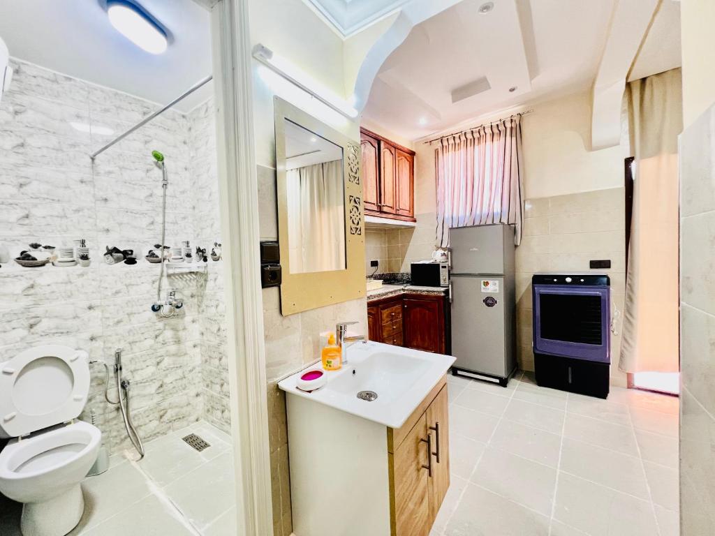 马拉喀什Famille Hanae appartement avec terasse的浴室配有卫生间、盥洗盆和淋浴。