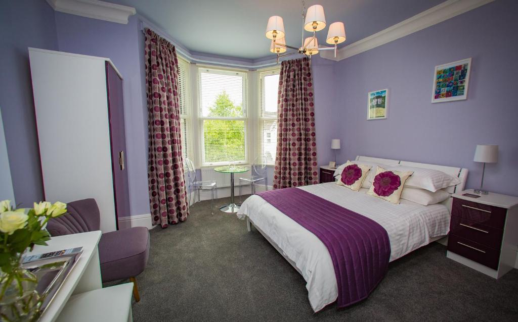 梅瑟蒂德菲尔格林豪尼一室公寓的一间卧室配有一张紫色墙壁和窗户的床