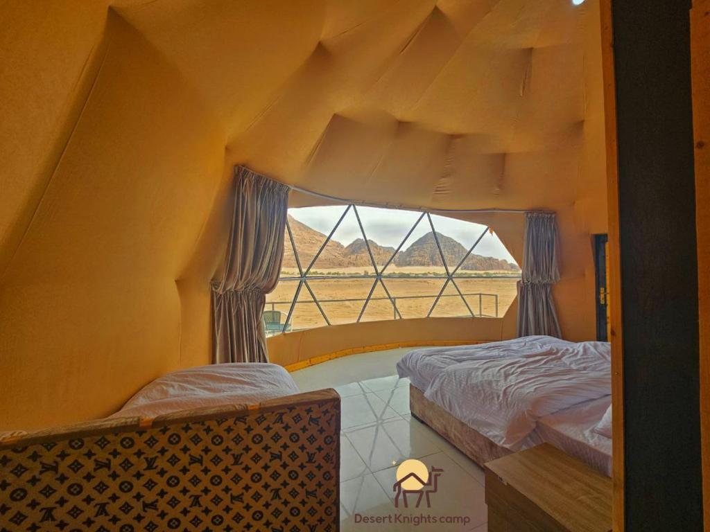 瓦迪拉姆Desert Knights camp的客房设有两张床和窗户。