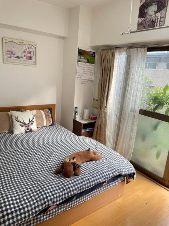 东京桜宿-ダブルベッドの小さなガーデンルーム的一间卧室,配有一张带两个泰迪熊的床