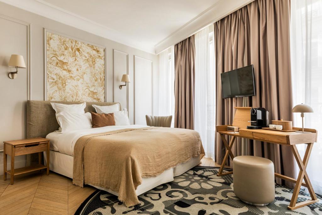 巴黎Maison Pigalle的酒店客房,配有床和电视