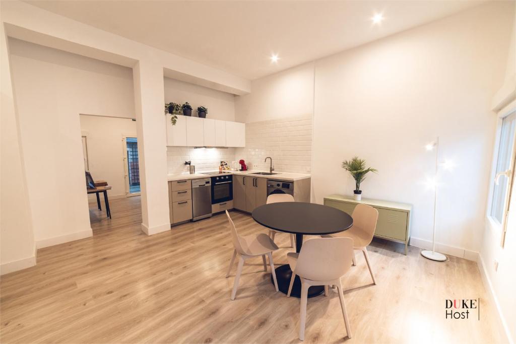 马德里5Torres Apartment的厨房以及带桌椅的用餐室。