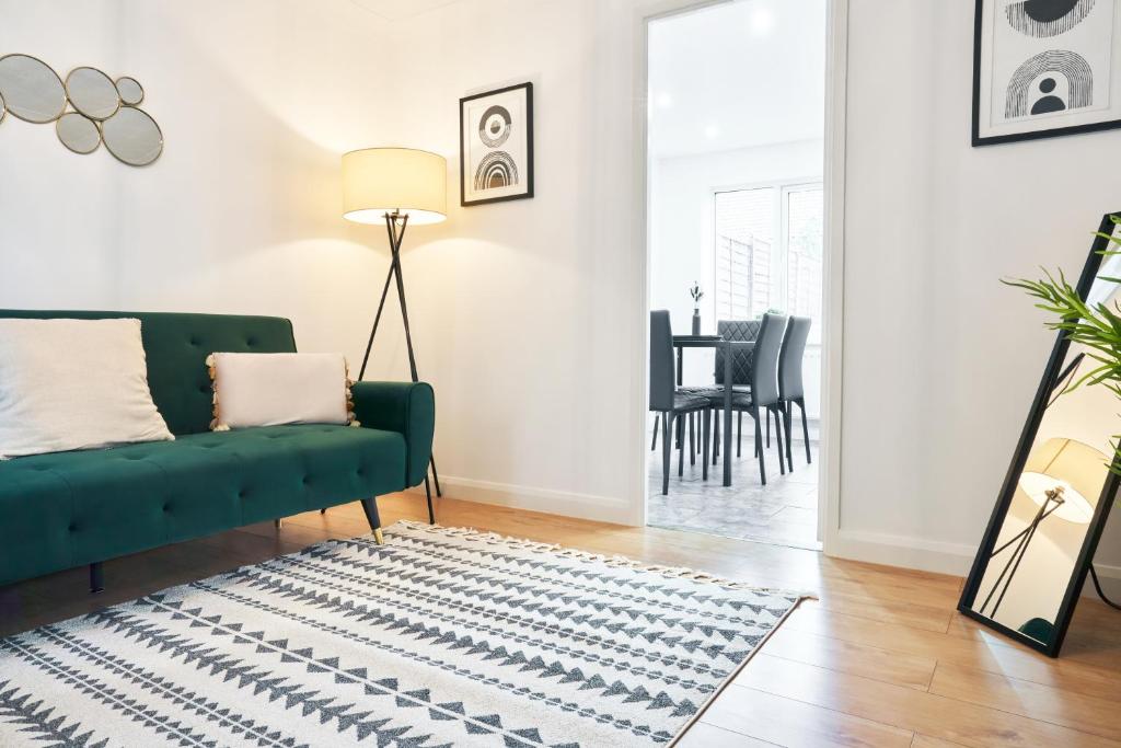 Loughton3 Bedroom Home in Central Milton Keynes的客厅配有绿色沙发和地毯。