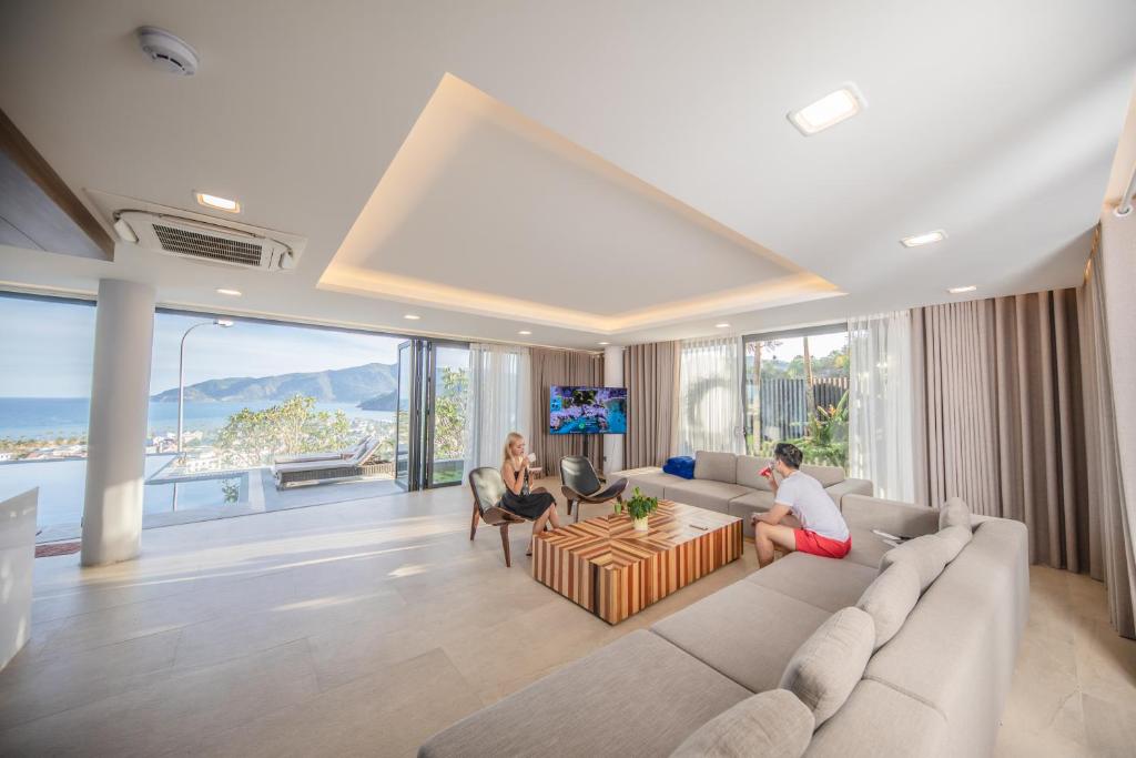 芽庄Nha Trang Oceanfront Luxury Villa Anh Nguyen的客厅,沙发上设有两人座位
