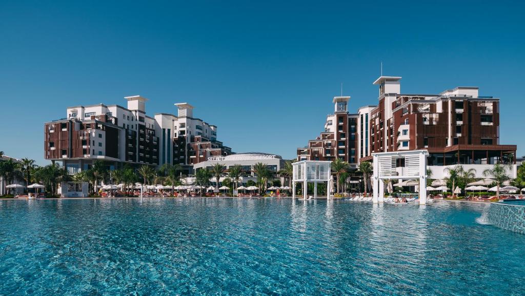 贝莱克Selectum Luxury Resort Belek的一座位于城市的游泳池,有高大的建筑