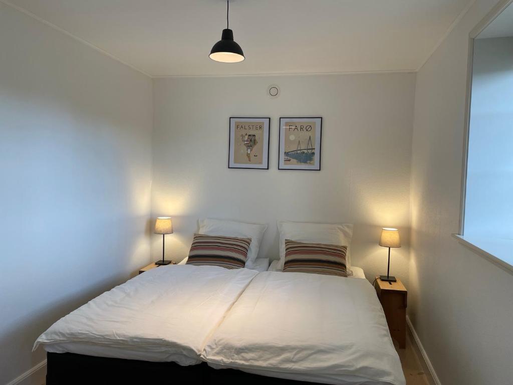 尼克宾法尔斯特Strandby 1847 B&B的一间卧室,两边都配有一张床和两盏灯
