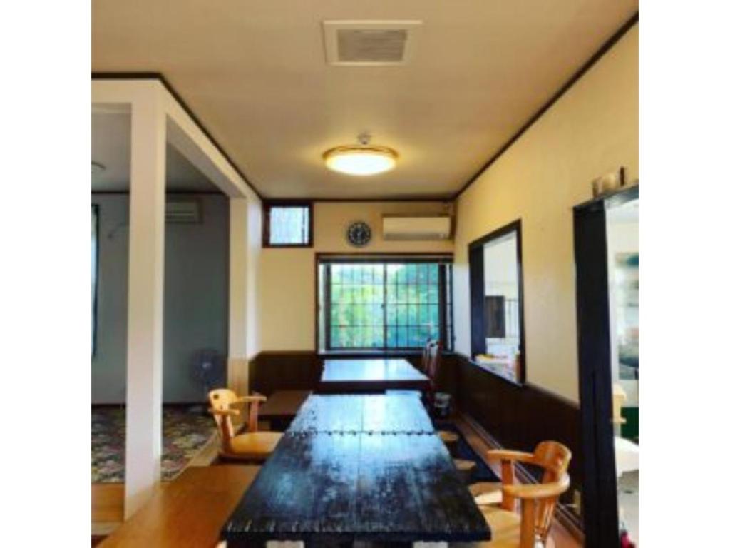 壹岐市Asobiyahouse Iki - Vacation STAY 30418v的配有长桌子和椅子的长客房