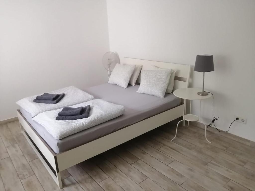 维也纳Excellent Apartment M&L的白色的床、白色枕头和桌子